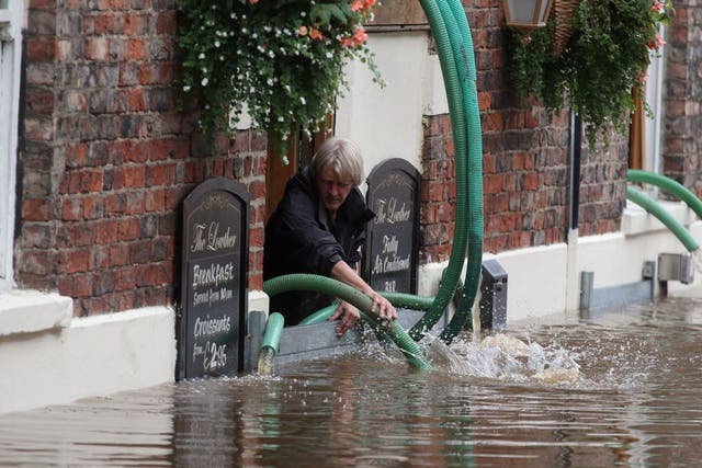 A pub landlord battles with River Ouse floodwater in York this week 