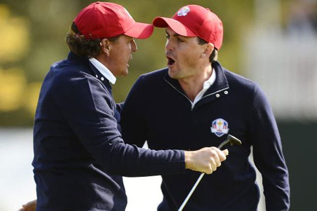 Phil Mickelson (left) and Keegan Bradley celebrate after the latter’s winning putt on the 15th hole
