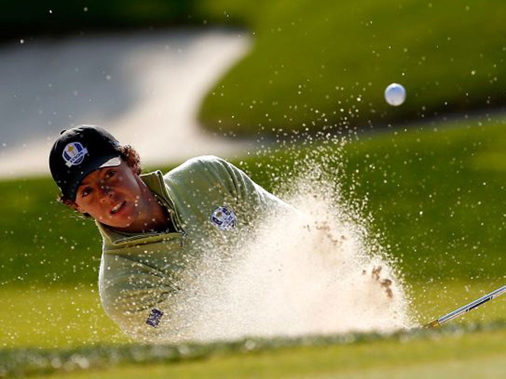 Rory McIlroy plays out of a bunker on the 10th hole yesterday