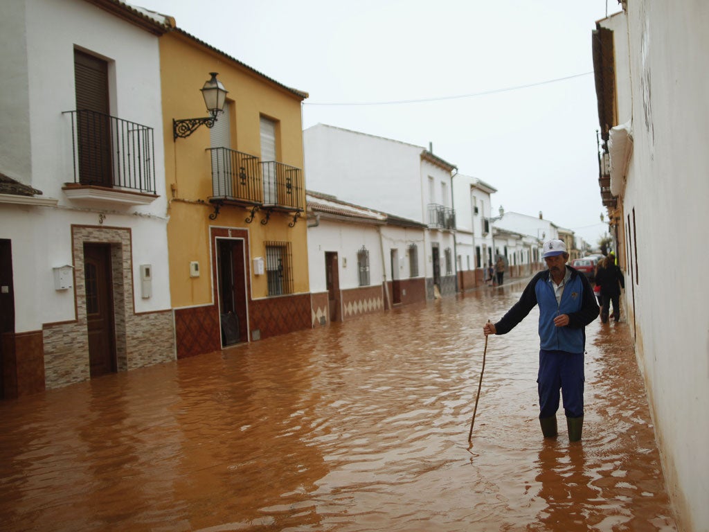 A man wades through floodwaters in Bobadilla, near Malaga in southern Spain