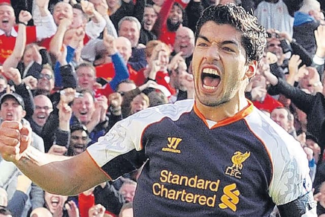 Luis Suarez celebrates after scoring his second goal against Norwich