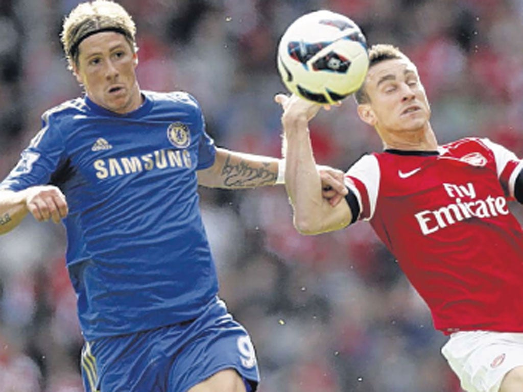 Fernando Torres (left) gets the better of Arsenal’s Laurent Koscielny