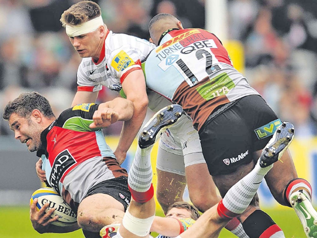 A bandaged Owen Farrell helps to bring down Harlequins’ Nick Easter