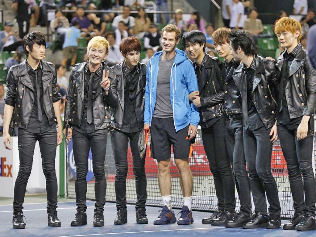 Andy Murray meets the South Korean pop group A-peace before practice in Tokyo yesterday