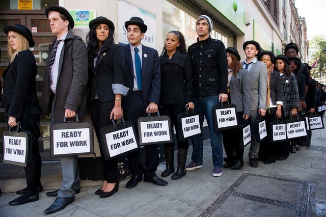 British musicians Miss Dynamite (5th L) and Charlie Simpson (6th L) join unemployed young people as they stand in line outside a job centre in central London