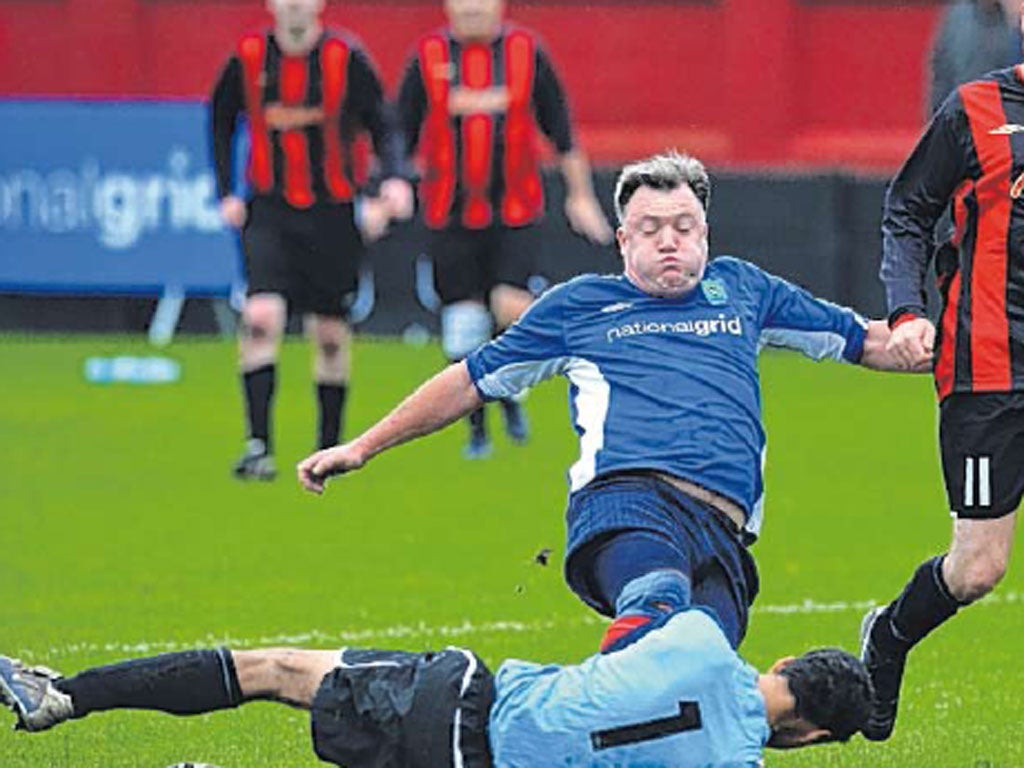 Shadow Chancellor Ed Balls in a tackle at a football match between
Labour MPs and journalists in Salford