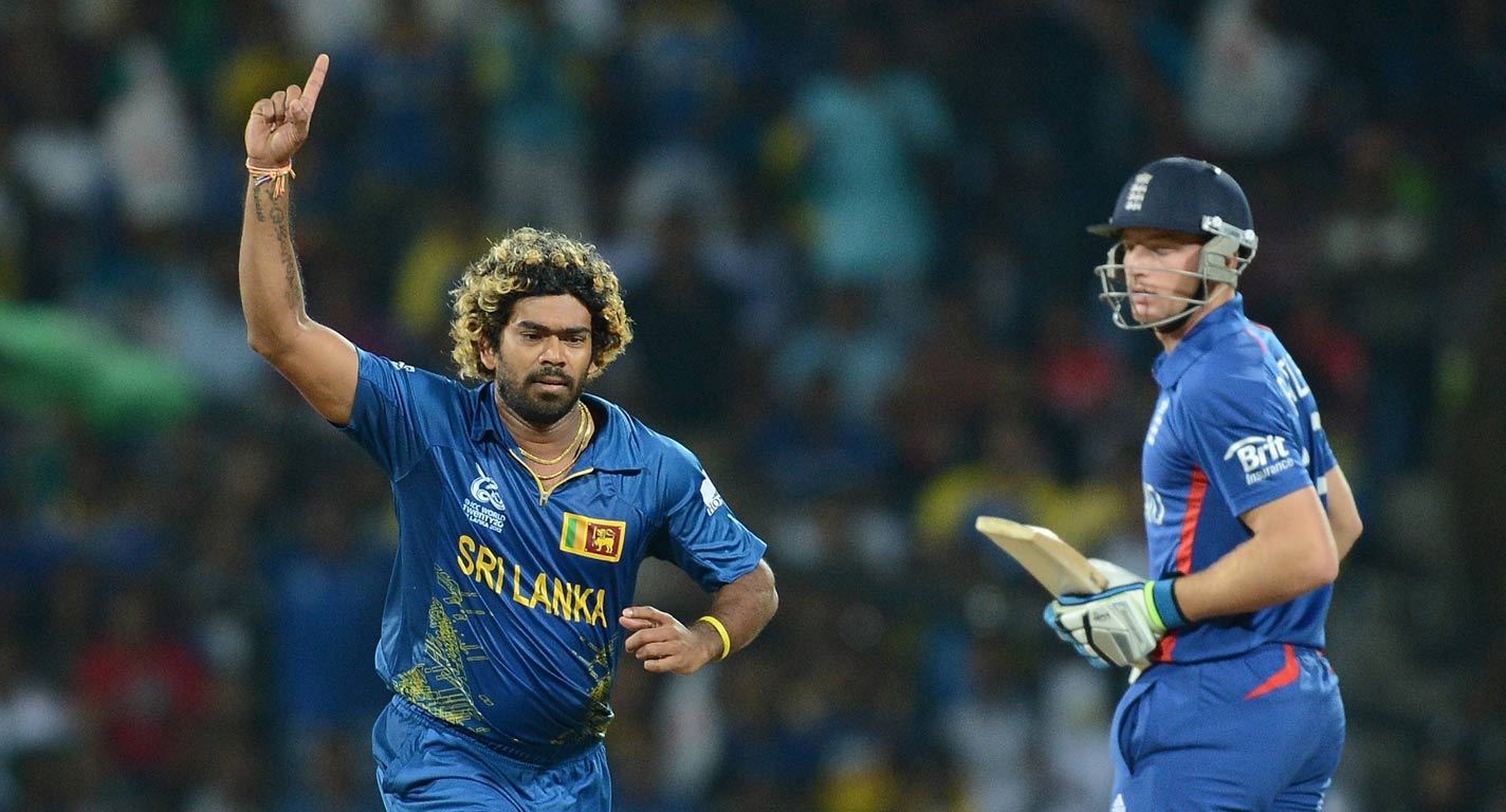 Sri Lankan cricketer Lasith Malinga (L) celebrates the wicket of England's Jos Buttler