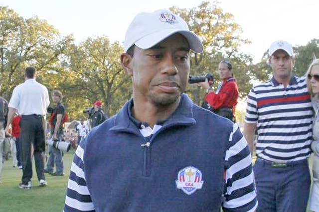 USA's Tiger Woods walks off the course as Europe celebrates their win at the Ryder Cup 