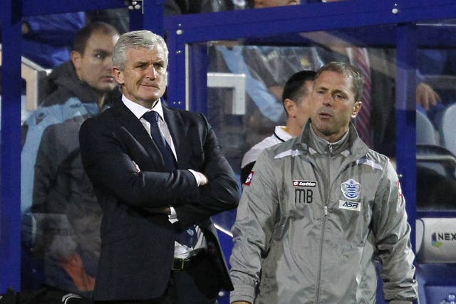 QPR manager Mark Hughes looks on during his side's defeat to West Ham