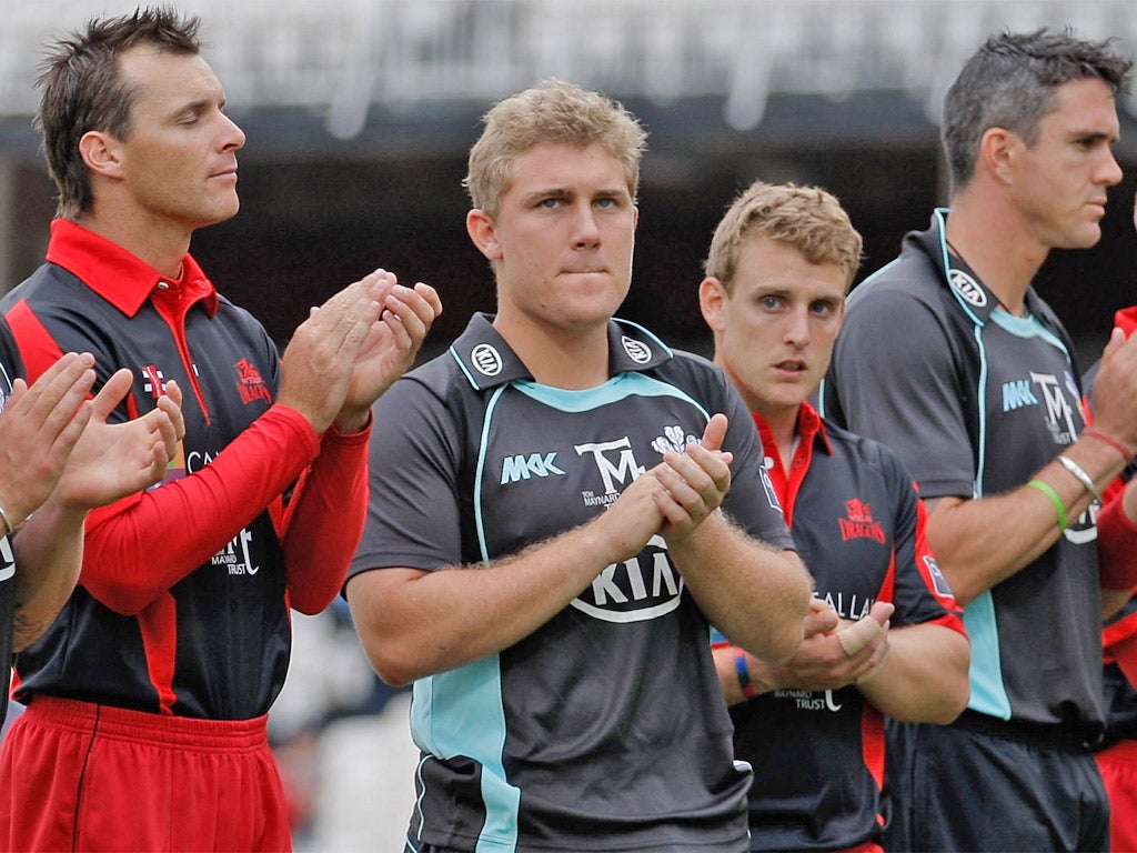 Rory Hamilton-Brown (second left) takes part in a tribute to Tom Maynard before a game between Surrey and Glamorgan