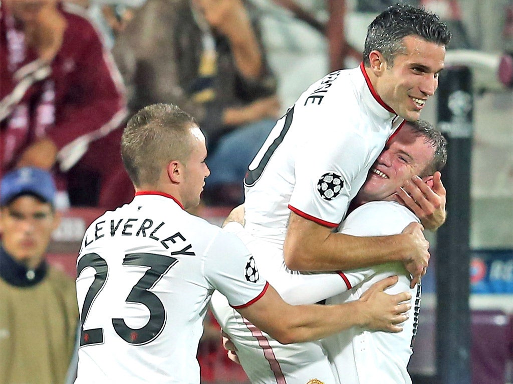 Robin van Persie is congratulated by Wayne Rooney and Tom Cleverley after scoring United's winner