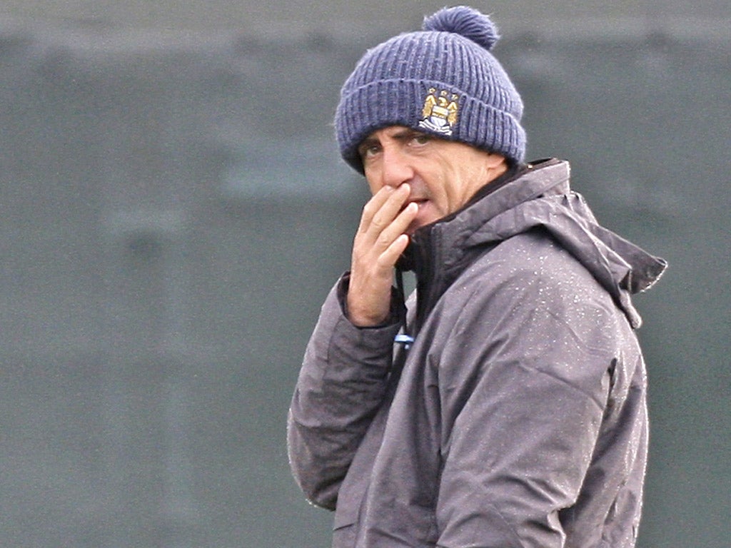 Roberto Mancini oversees City's training at Carrington yesterday