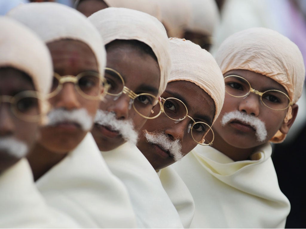 Under-priviledged Indian children dressed as their country's founding father Mahatma Gandhi are seen gathered for a function in Kolkata on January 29, 2012