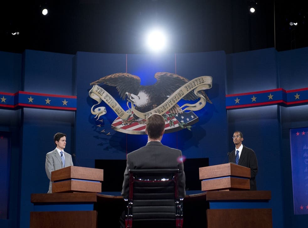 Dia Mohamed (R), a stand-in for US President Barack Obama, and Zach Gonzales, a stand-in for Republican Presidential nominee Mitt Romney, both students at the University of Denver, participate in a rehearsal for the first presidential debate
