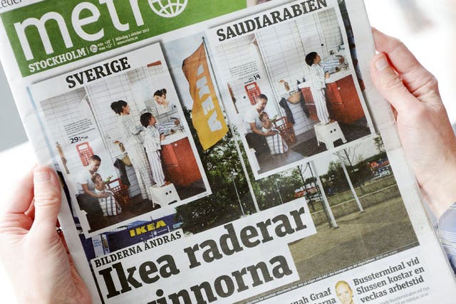 A person holds in Stockholm the October 1, 2012 issue of the free daily Metro newspaper, featuring two versions of the same photo from Swedish furniture giant Ikea's yearly catalogue