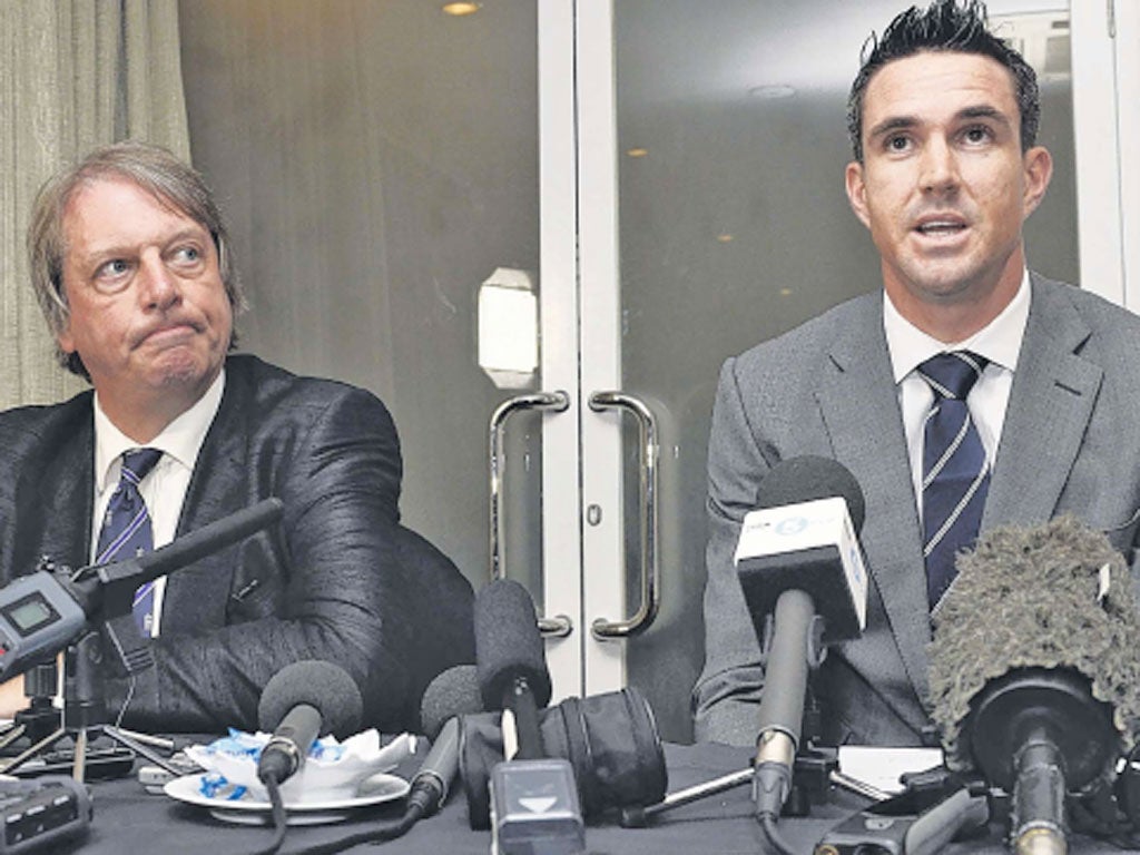 ECB chairman Giles Clarke listens to Kevin Pietersen speak at a
news conference in Colombo yesterday