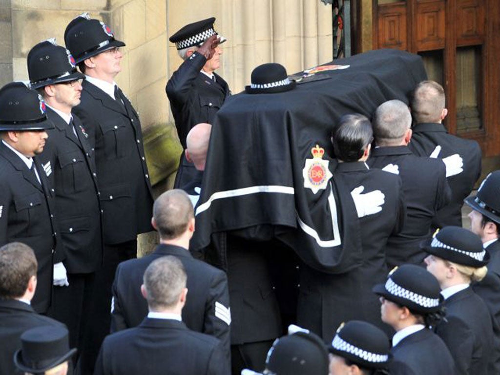 Greater Manchester Police Chief Constable, Sir Peter Fahy, salutes as the coffin of Pc Fiona Bone, one of the two policewoman murdered in a gun and grenade attack, is carried into Manchester Cathedral