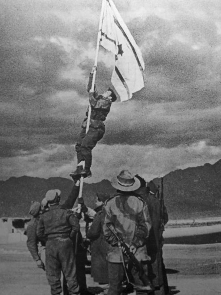 Birth of a nation: Adan raises an improvised Israeli flag at Eilat in
March 1949, indicating the end of the War of Independence