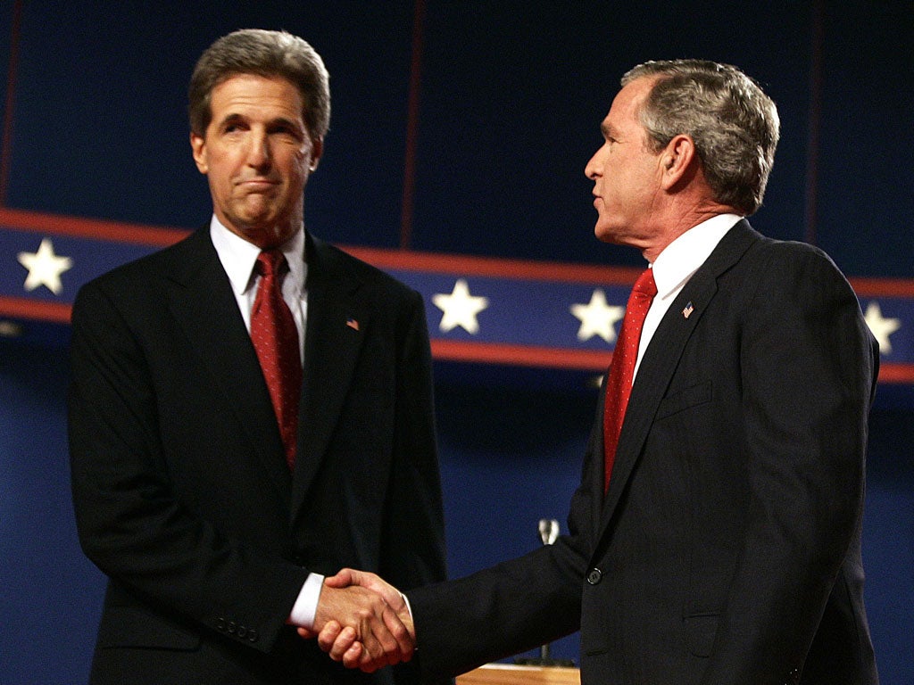George W Bush and John Kerry before their debate in 2004. Mr Kerry was drafted in to prepare Mr Obama for his showdown with Mitt Romney