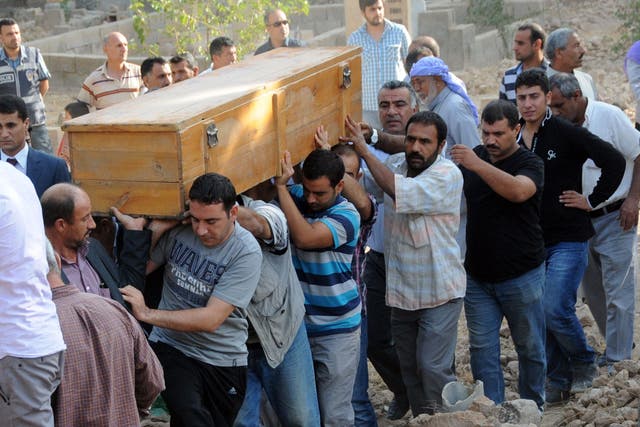 Mourners carry the coffin of one of the five civilians killed in Akcakale