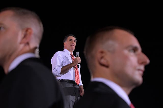 US Republican presidential candidate Mitt Romney speaks as secret service members keep guard during a campaign rally in Fishersville, Virginia