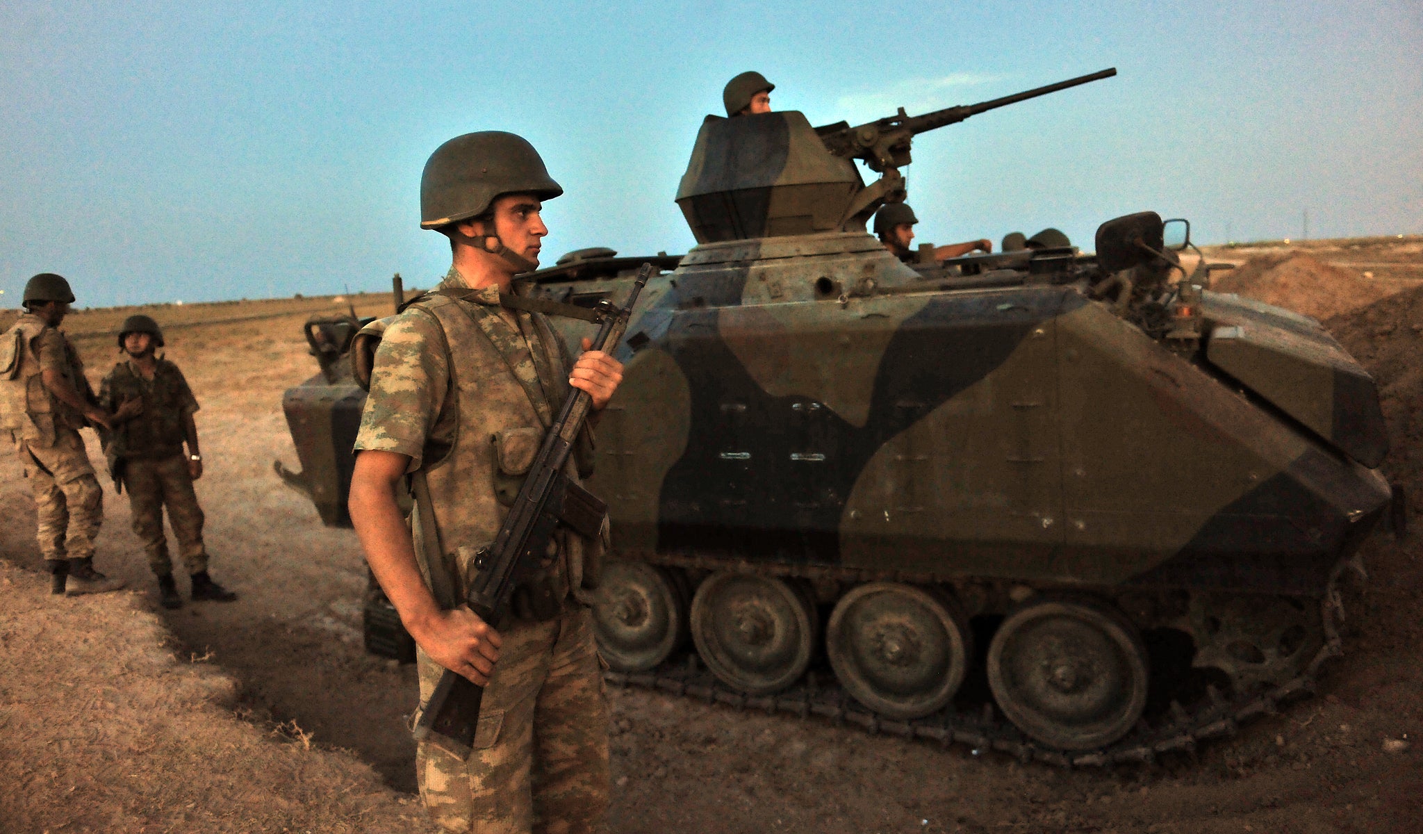 Turkish soldiers stand guard in Akcakale by the Turkish-Syria border in southern Sanliurfa province