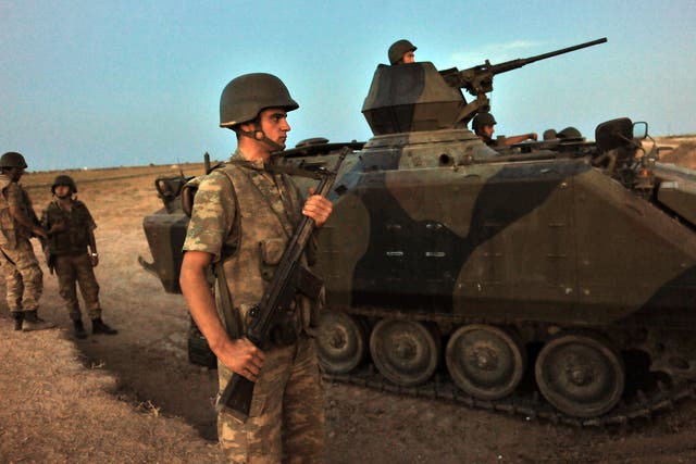 Turkish soldiers stand guard in Akcakale by the Turkish-Syria border in southern Sanliurfa province