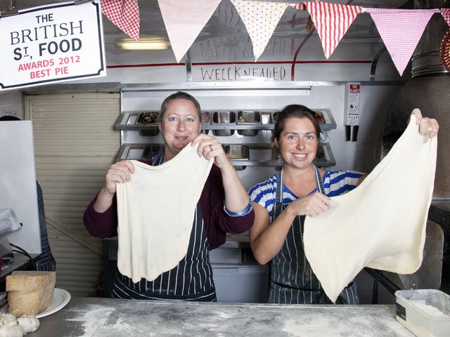 Lisa Markwell (left) is shown how to work pizza dough by Well Kneaded’s Bridget Goodwin