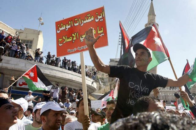 Demonstrators take to the  streets of Amman yesterday