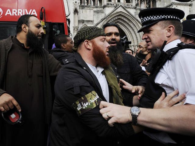 Protesters supporting the terror suspects clash with police at the court yesterday
