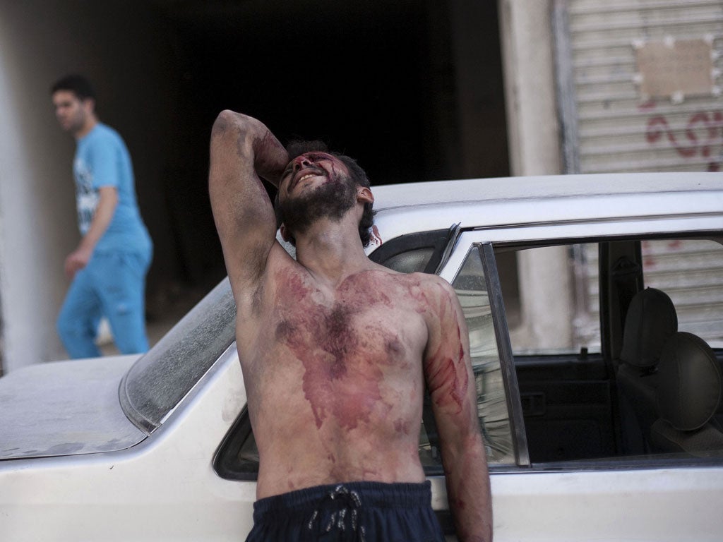 Grief and pain: Outside an Aleppo hospital after Syrian planes attacked a school last week