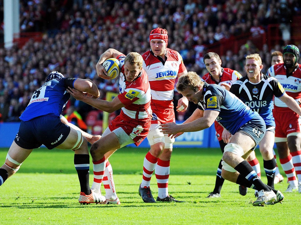 Breaking point: Gloucester's Billy Twelvetrees tries to avoid a tackle in the fierce derby match against Bath