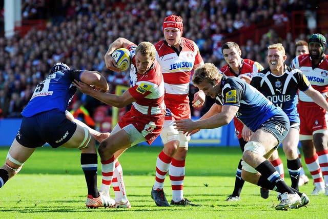 Breaking point: Gloucester's Billy Twelvetrees tries to avoid a tackle in the fierce derby match against Bath