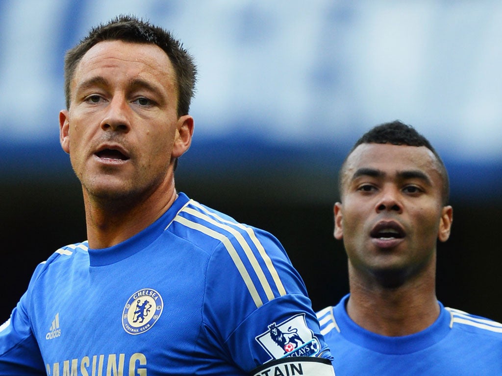 Double trouble: John Terry (left) and Ashley Cole are a study in concentration during yesterday's 4-1 victory over Norwich at Stamford Bridge, but although fans backed them, Cole is to be disciplined
