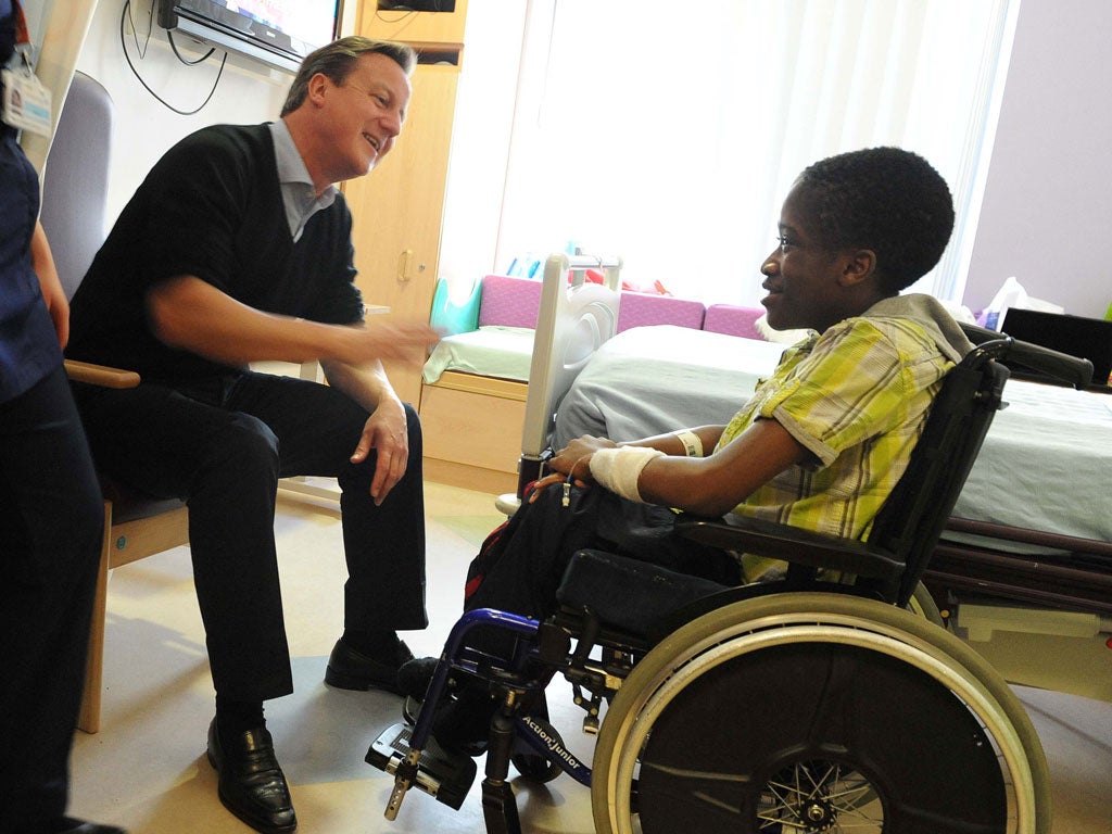 Bedside manner: David Cameron spent yesterday visiting patients at a hospital in Oxford