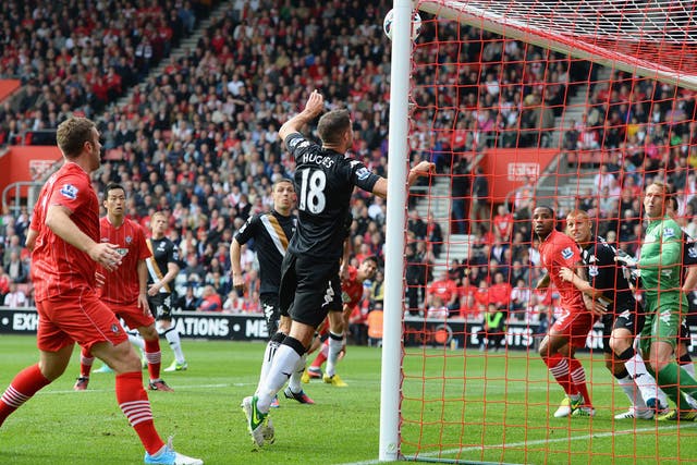 Aaron Hughes of Fulham can't prevent a looping header from Jose Fonte