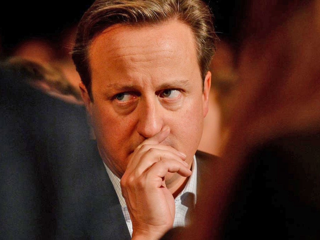 David Cameron listens to a speech by William Hague on the first day of the Conservative party conference