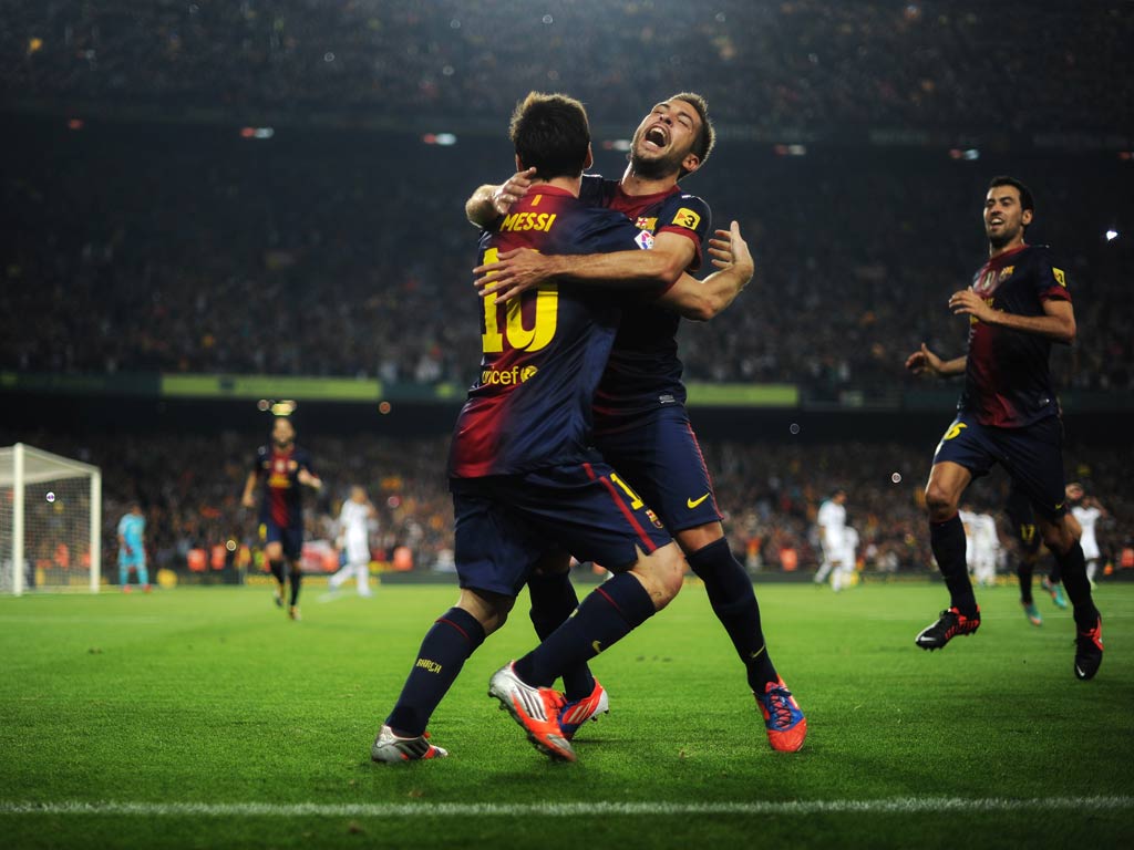 Lionel Messi celebrates after scoring his second against Real Madrid