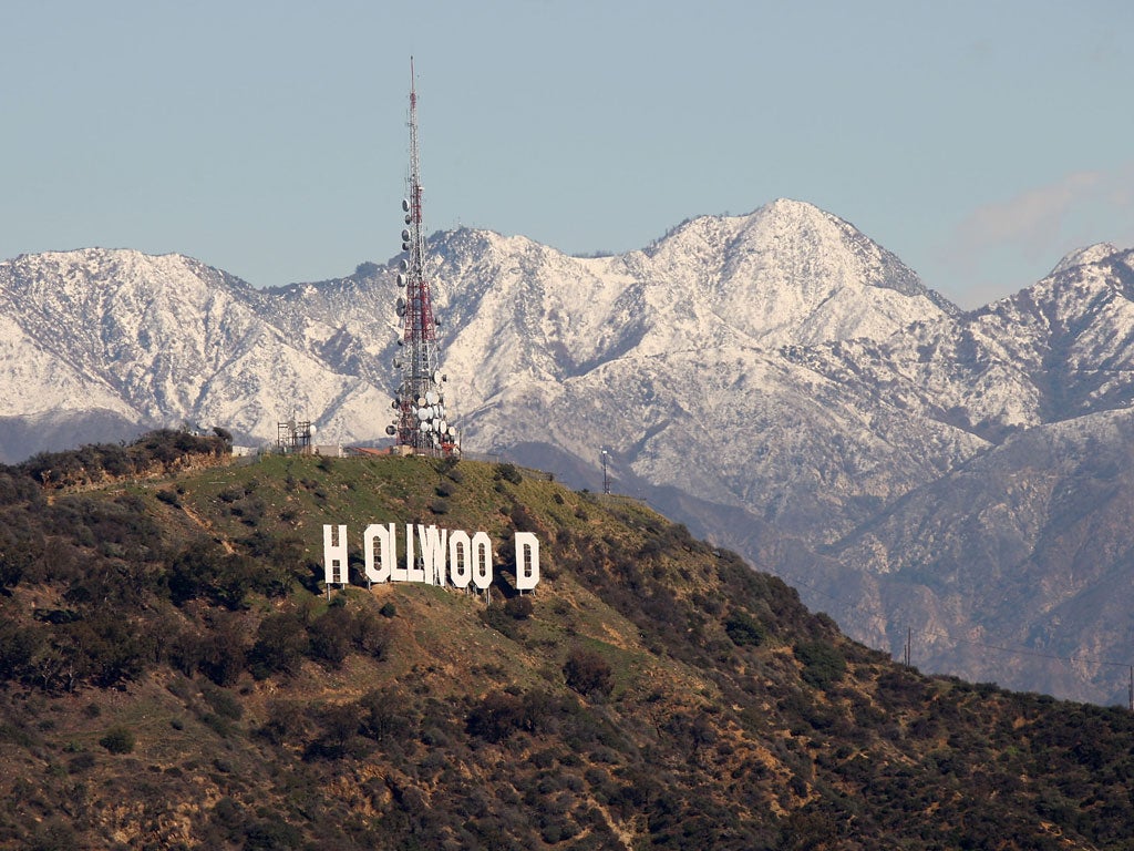 The 450-foot-long Hollywood sign and the undeveloped land that surrounds it are seen against the snow-covered San Gabriel Mountains as a storm breaks up on February 10, 2010 in Los Angeles, California.