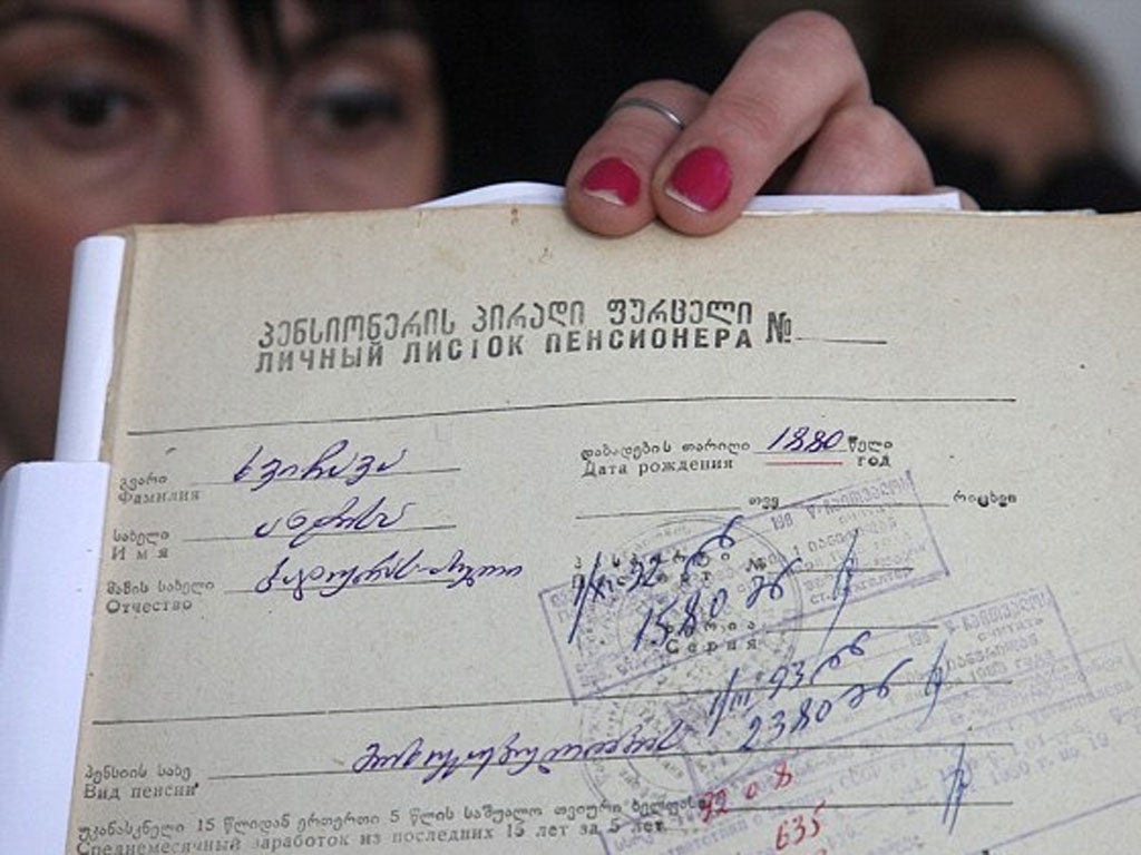 A Georgian local official shows a document with the birth date of Mrs Khvichava in Sachino