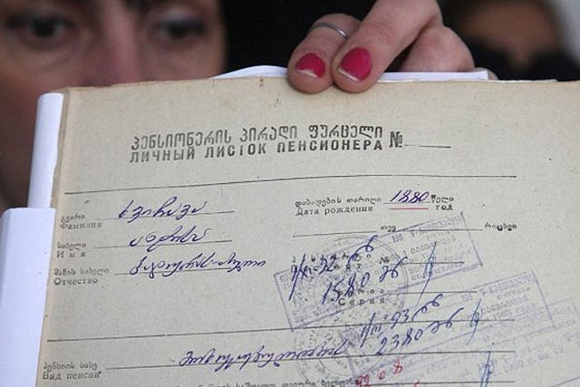 A Georgian local official shows a document with the birth date of Mrs Khvichava in Sachino