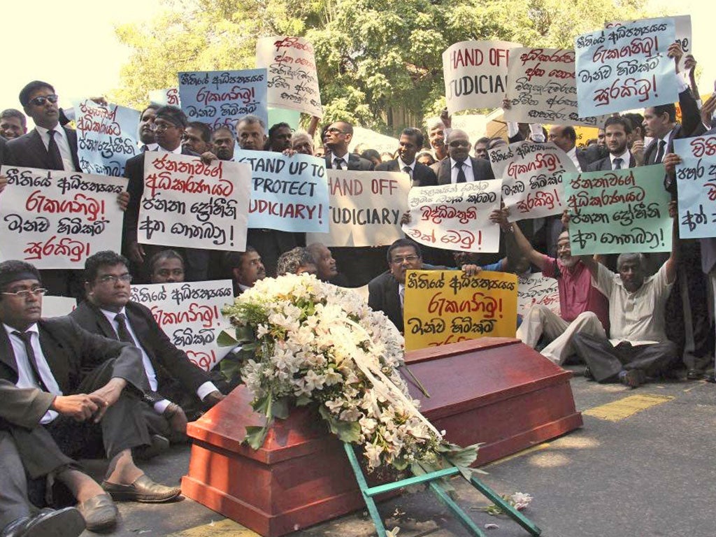 Sri Lanka's judges and lawyers demonstrate next to a coffin which they said symbolised the death of independent judiciary as they protest outside a court complex in Colombo, Sri Lanka