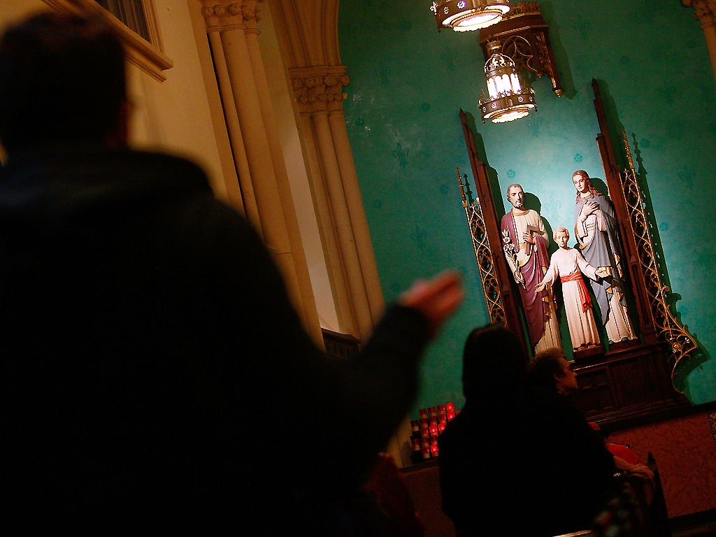 A parishioner worships at a Roman Catholic church in New York City