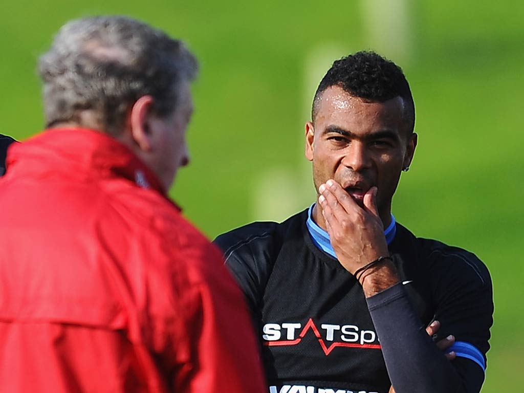 Ashley Cole takes instructions from Roy Hodgson