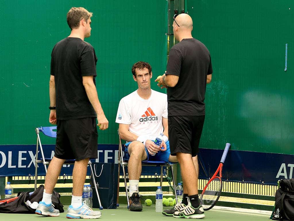 Andy Murray of Great Britain talks to Andy Ireland and Jez Green after his practice in Shanghai