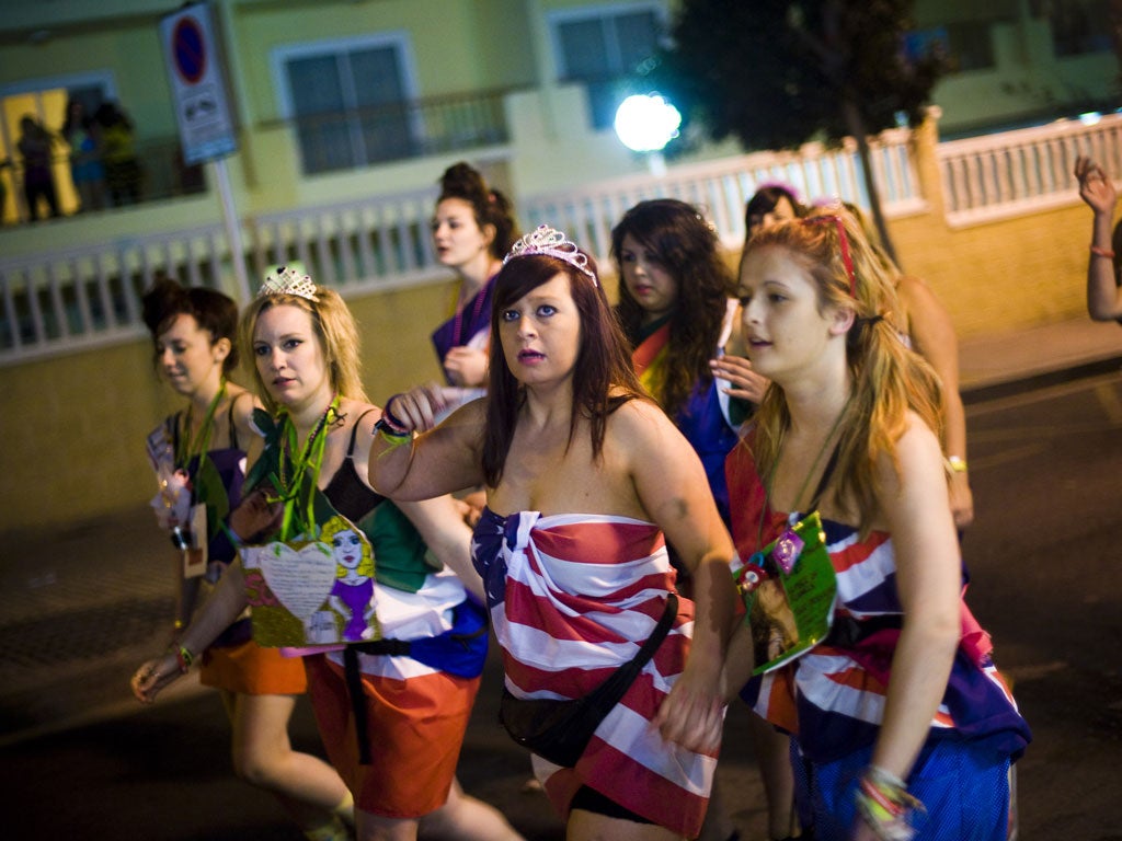 British students in fancy dress walk through the streets during the first night of parties during the SalouFest on April 1, 2012 in Salou, Spain.