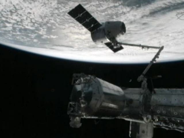 The capture of the Dragon capsule by a robot arm on the International Space Station