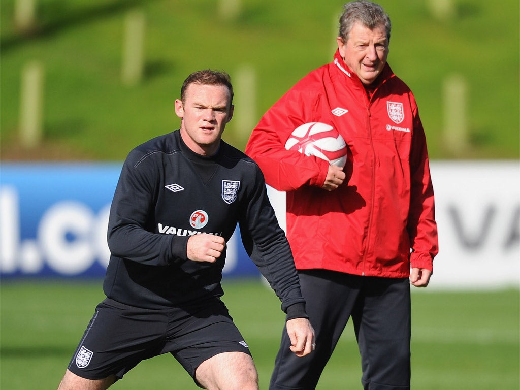 Roy Hodgson keeps a close eye on Wayne Rooney during training yesterday