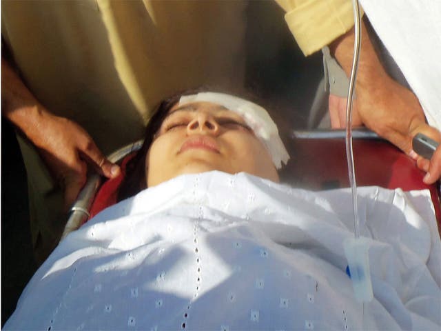 Malala Yousafzai is carried away on a stretcher by medics following the attack