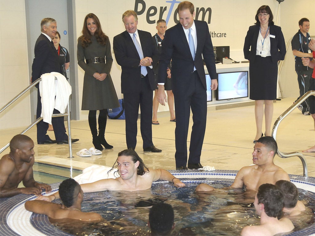 The Duke and Duchess of Cambridge greet England footballers as they soak in the hot-tub at St George's Park